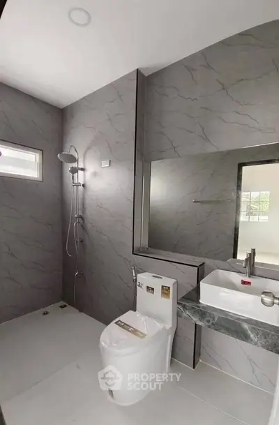 Modern bathroom with sleek gray tiles and contemporary fixtures