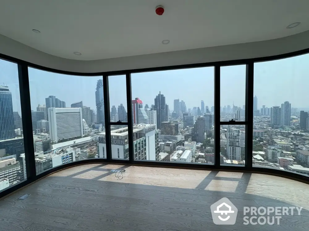 Stunning panoramic city view from high-rise apartment with floor-to-ceiling windows