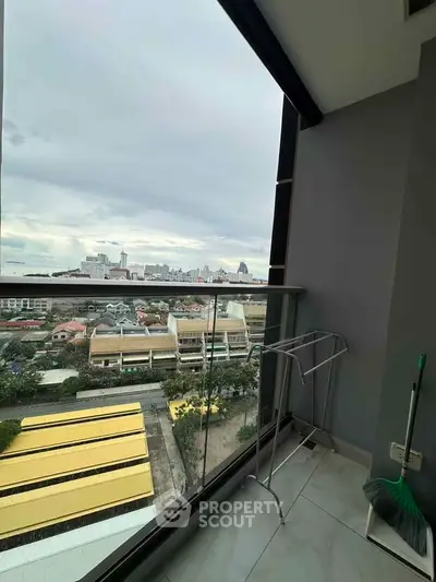 Stunning city view from a modern balcony with glass railing, perfect for relaxation and enjoying urban landscapes.