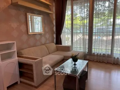 Charming living room with elegant decor and large windows offering natural light.
