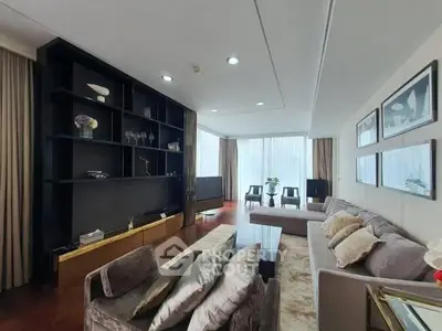 Luxurious living room with modern decor and large windows offering natural light.