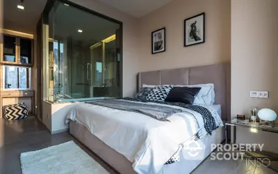 Chic modern bedroom with en-suite glass-walled bathroom, plush bedding, and stylish decor, perfect for urban living.