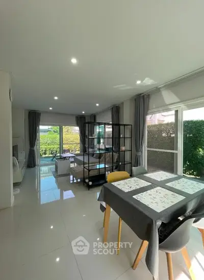 Spacious modern living room with large windows and garden view