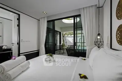 Luxurious bedroom with poolside view and elegant decor