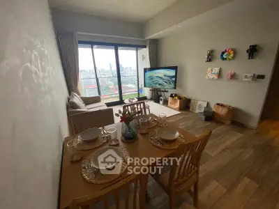 Modern living room with dining area and city view, featuring stylish decor and natural light.