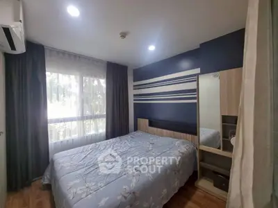 Cozy bedroom with modern decor and large window for natural light