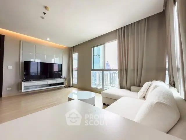 Spacious modern living room with large windows and stylish furniture