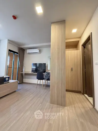 Modern living room with sleek wooden flooring and stylish furniture in a contemporary apartment.