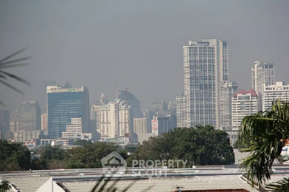Stunning city skyline view with modern high-rise buildings and lush greenery.