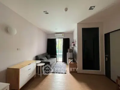 Modern living room with sleek furniture and balcony view