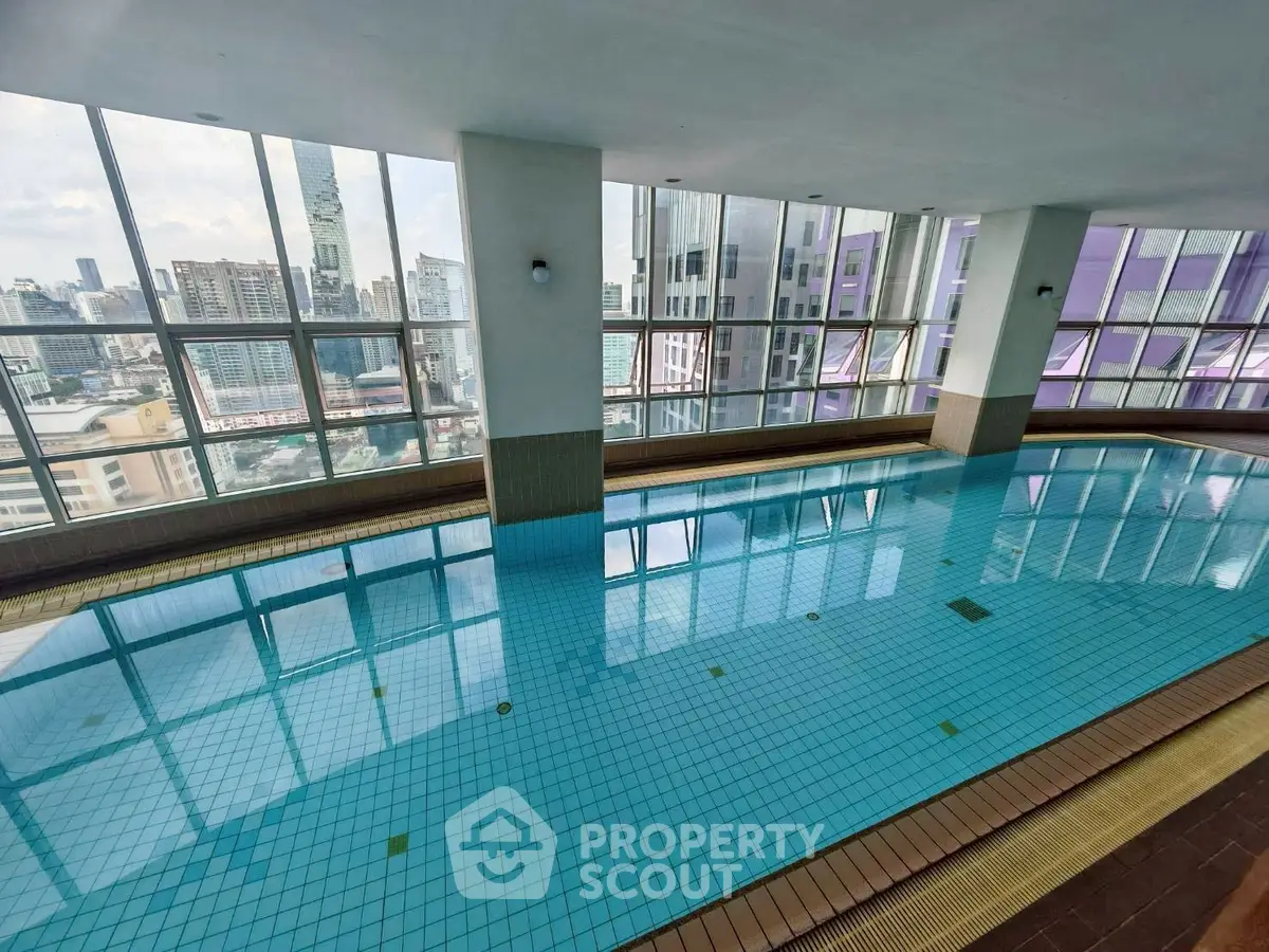 Luxurious indoor pool with stunning city views in high-rise building