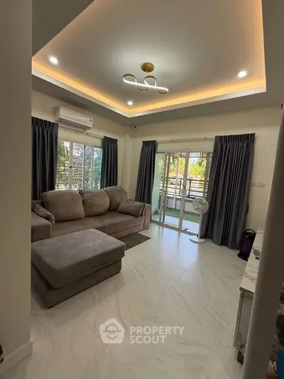 Modern living room with cozy sofa and balcony view