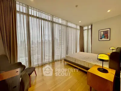 Spacious bedroom with floor-to-ceiling windows and modern decor