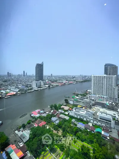 Stunning river view from high-rise apartment showcasing city skyline and lush greenery.