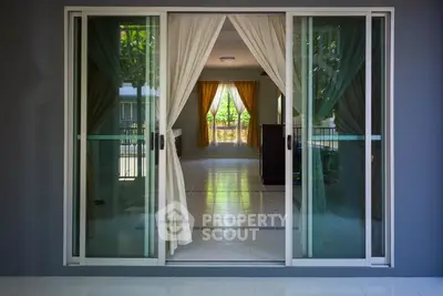 Elegant living room with large sliding glass doors and lush garden view