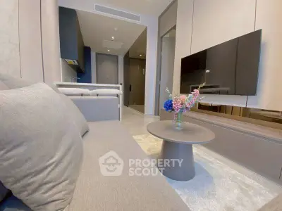 Modern living room with sleek furniture and wall-mounted TV, perfect for urban living.