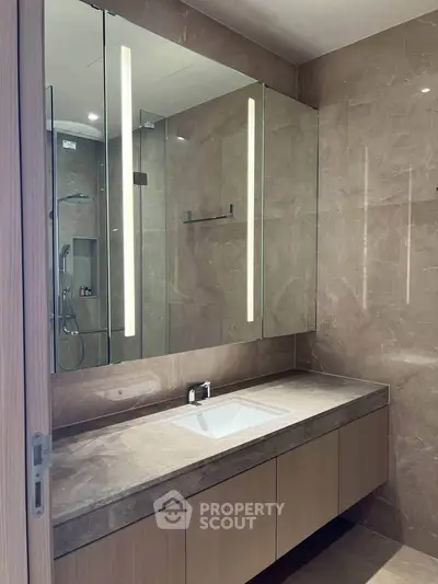 Luxurious modern bathroom with elegant marble finishes and sleek vanity design.