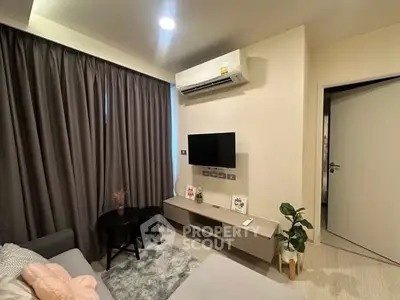 Modern living room with air conditioning, TV, and stylish decor in a cozy apartment.