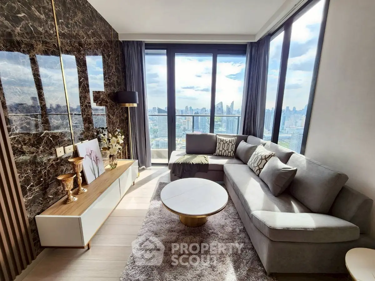 Luxurious living room with panoramic city view, elegant decor, and plush furnishings.