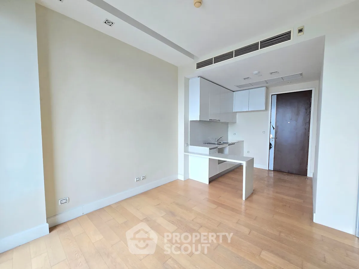 Modern apartment with open kitchen layout and wooden flooring, perfect for contemporary living.