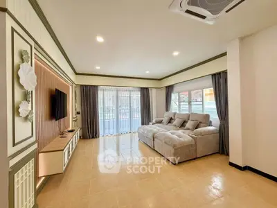 Spacious living room with modern decor and large windows for natural light.