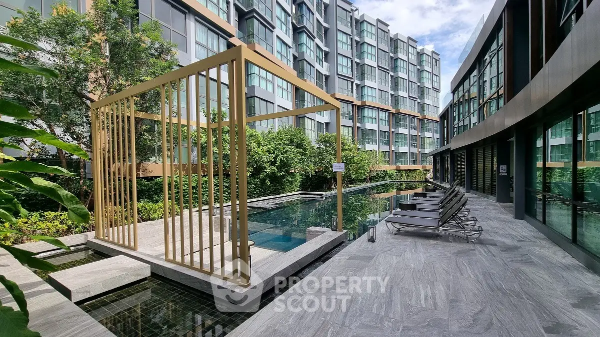Luxurious modern apartment complex with stunning pool and stylish architecture.
