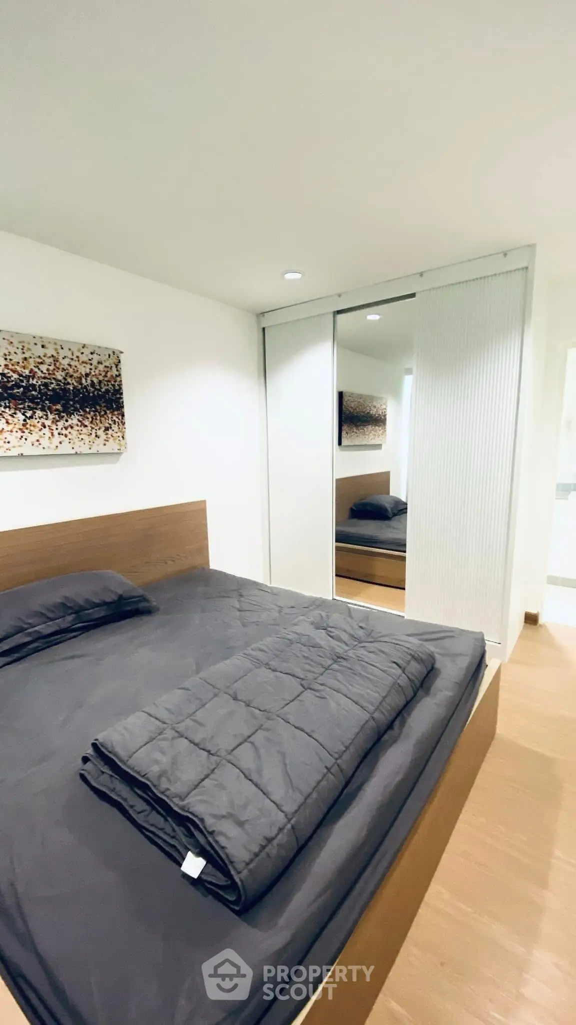 Modern bedroom with sleek design and mirrored closet doors