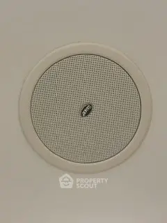 Ceiling-mounted speaker in modern home interior for enhanced audio experience.