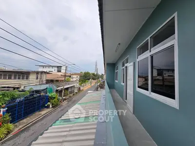 Spacious balcony with street view in a residential area, perfect for enjoying outdoor relaxation.