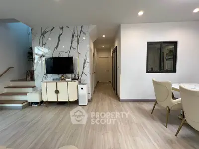 Modern living room with stylish decor and elegant dining area