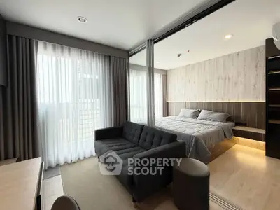 Modern bedroom with stylish decor and natural light in a contemporary apartment.