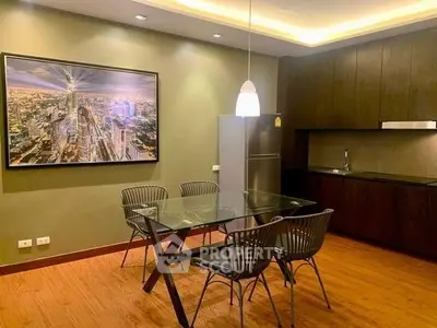 Modern kitchen with glass dining table and sleek cabinetry