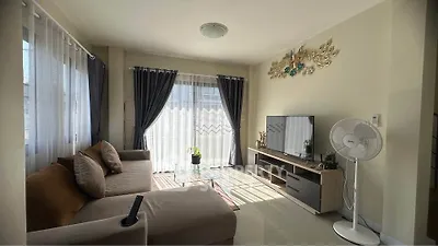 Bright and cozy living room with modern decor and ample natural light.