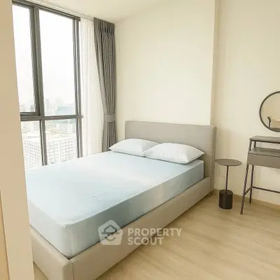 Modern bedroom with large window and minimalist decor in high-rise apartment.