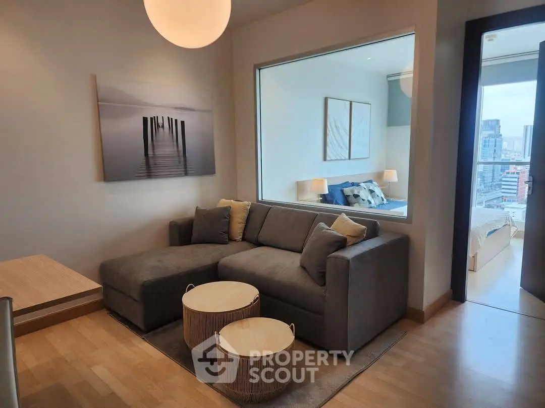 Modern living room with cozy sofa and city view, perfect for urban living.