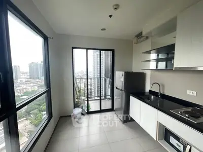 Modern kitchen with city view and sleek appliances in high-rise apartment