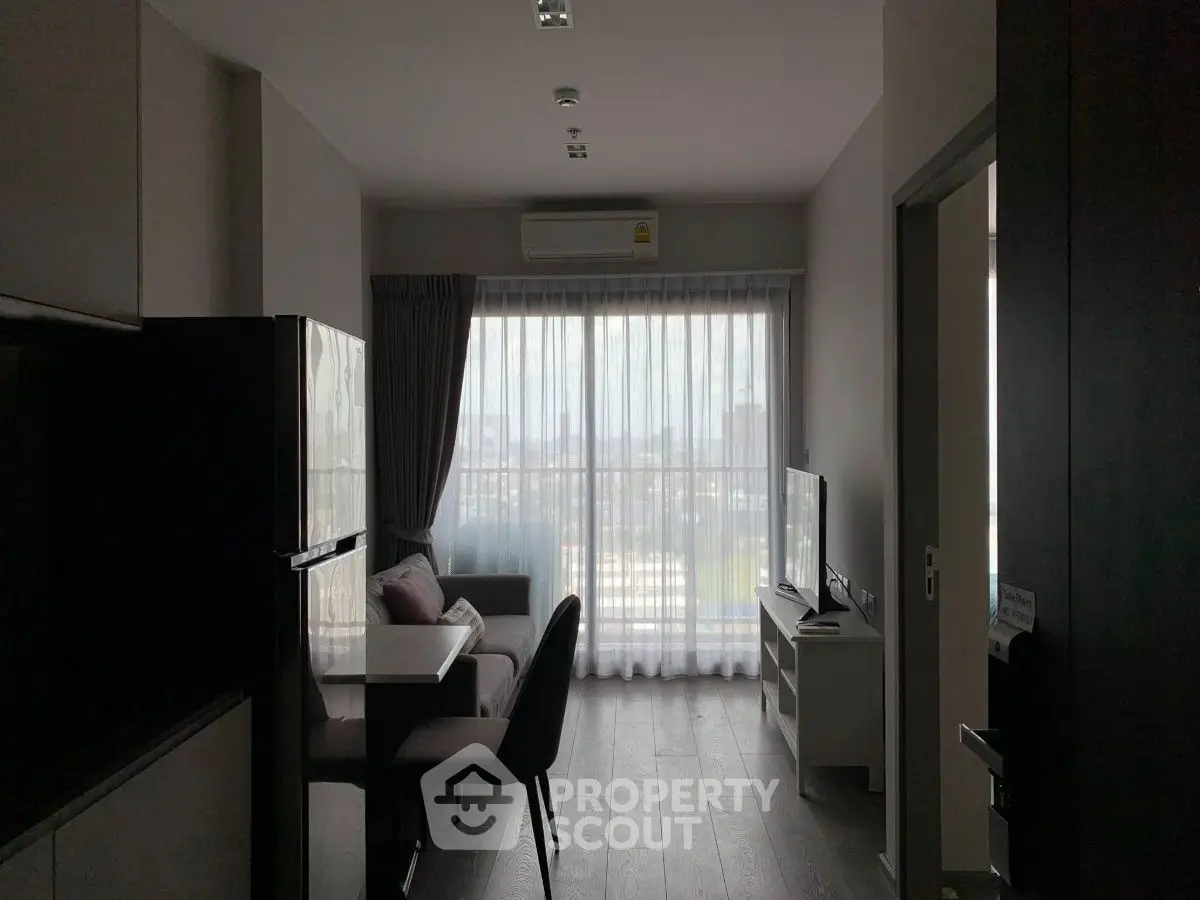 Modern living room with city view, sleek furniture, and natural light.