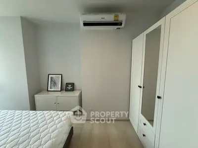 Modern bedroom with air conditioning and stylish furniture in a bright, minimalist design.