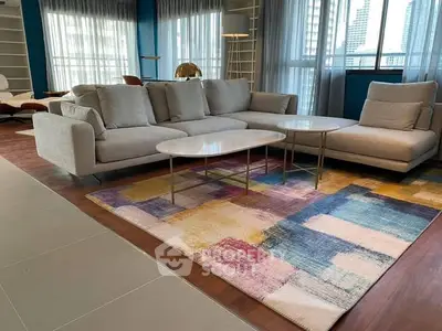 Spacious modern living room with stylish sofa and colorful rug