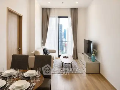 Modern living room with city view, stylish furniture, and elegant decor in a high-rise apartment.