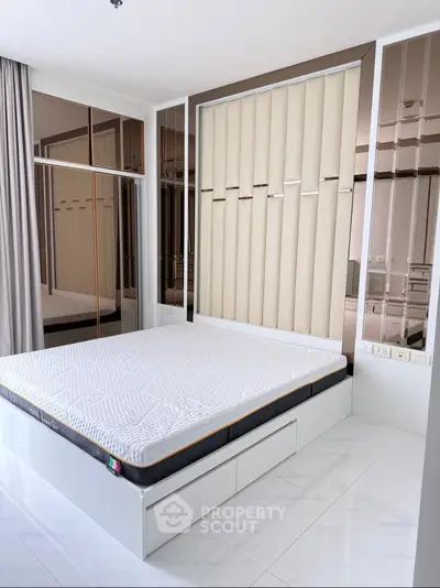 Modern bedroom with sleek design and ample storage in a luxury apartment.