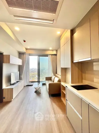 Modern living room with sleek design and balcony view in a high-rise apartment.