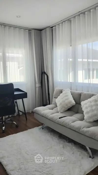 Bright and modern living room with cozy sofa and stylish decor