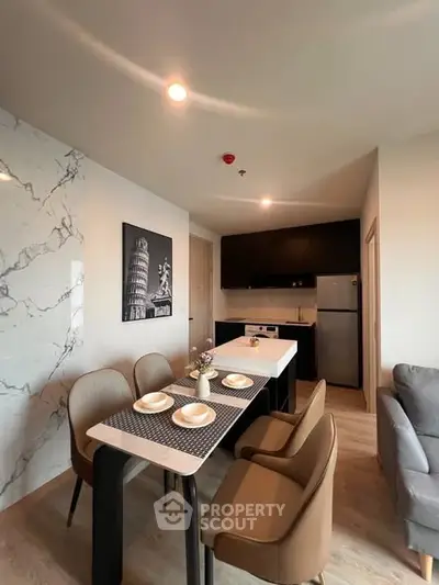 Modern kitchen and dining area with stylish decor and marble accent wall
