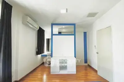 Spacious bedroom with modern design and wooden flooring