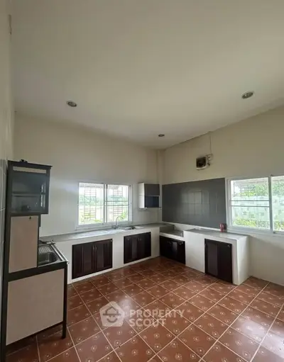 Spacious kitchen with tiled floor and ample natural light