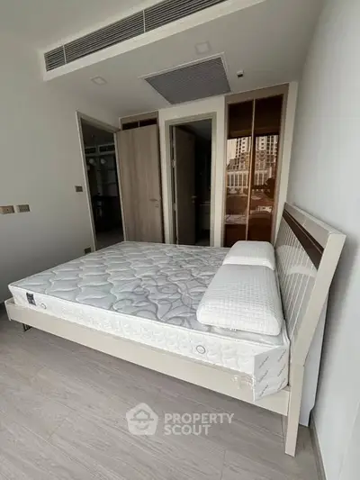 Spacious bedroom with modern design and large windows for natural light.