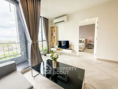 Modern living room with sleek design and city view balcony access