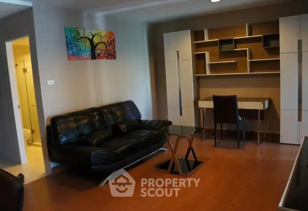 Modern living room with stylish furniture and vibrant wall art in a cozy apartment.