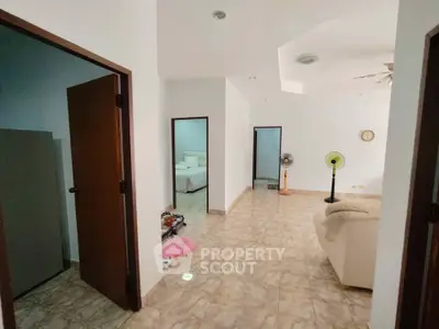 Spacious interior with tiled flooring and cozy seating area, ideal for comfortable living.